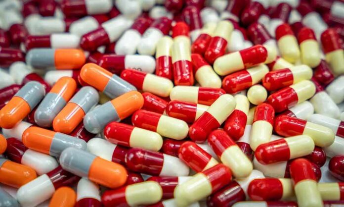 Assorted capsules in red, yellow, orange, and gray