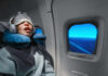 Airline Power Play: Seat Rights Exposed A passenger sleeping on an airplane with headphones and an eye mask