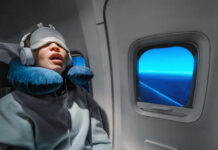 Airline Power Play: Seat Rights Exposed A passenger sleeping on an airplane with headphones and an eye mask