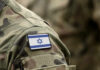 Wartime Mole Inside Israel’s Ranks Close-up of a military uniform with an Israeli flag patch