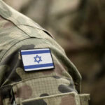 Wartime Mole Inside Israel’s Ranks Close-up of a military uniform with an Israeli flag patch