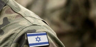 Wartime Mole Inside Israel’s Ranks Close-up of a military uniform with an Israeli flag patch
