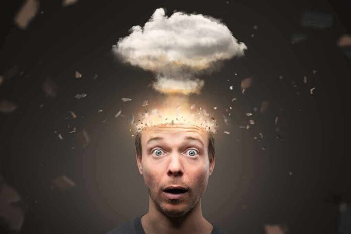 Surprised man with exploding head concept and cloud above