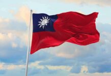 Drone Clock Ticks—Taiwan Risks Getting Swarmed Taiwan flag waving against a cloudy sky
