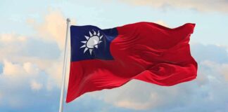 Taiwan flag waving against a cloudy sky