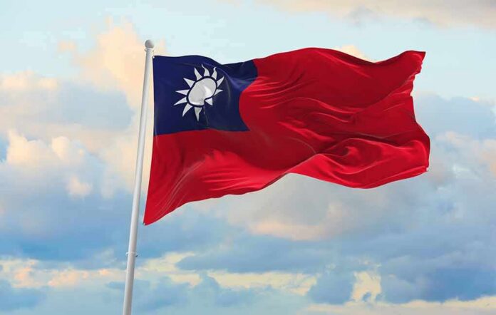 Taiwan flag waving against a cloudy sky