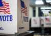 Slotkin’s ‘Secret Vote’ Claim Lacks Receipts Voting booths with American flags in a polling station