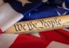 Progressives Plot Rewrite Of 1776 United States Constitution scroll on American flag