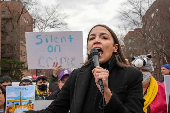 shutterstock_2139769939 woman speaking into a microphone at an outdoor protest