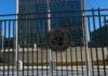 United Nations building with multiple international flags in front