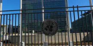 United Nations building with multiple international flags in front