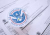 DHS Power Play Targets Welfare Green Cards Close-up of U.S. Department of Homeland Security seal on official documents