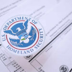 DHS Power Play Targets Welfare Green Cards Close-up of U.S. Department of Homeland Security seal on official documents
