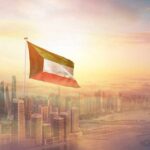 Kuwait Blames Iran—Tehran Points at Israel Kuwait flag flying over a modern city skyline at sunrise