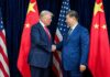 China Cries Bullying—The Real Pain Starts Next Two political leaders shaking hands in front of national flags