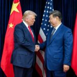 China Cries Bullying—The Real Pain Starts Next Two political leaders shaking hands in front of national flags
