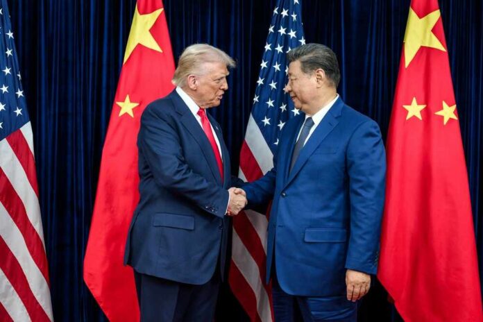 Two political leaders shaking hands in front of national flags