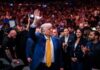 102 Alerts Ignored Before Trump Attack A man in a blue suit with a yellow tie waves to a cheering crowd