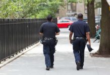 LA’s Cop Shortage Hits Alarming Low Two police officers walking on a city sidewalk