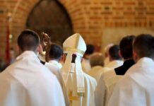 Bishops Revive Antipope Slur — Why Now? Bishop in white mitre among clergy during church procession