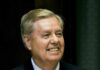 Graham’s Farewell Becomes Washington Power Play smiling man in suit and tie speaking at a microphone