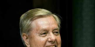 Graham’s Farewell Becomes Washington Power Play smiling man in suit and tie speaking at a microphone