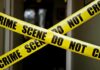 Yellow crime scene tape crossing a doorway