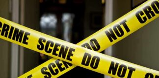Yellow crime scene tape crossing a doorway
