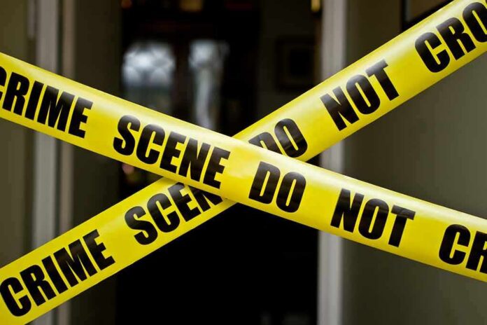 shutterstock_100885045 Yellow crime scene tape crossing a doorway