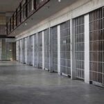 prison cell block with metal barred doors