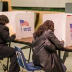 Voters filling out ballots at polling booths