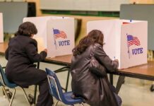 Emergency Election Takeover? Buckle Up Voters filling out ballots at polling booths