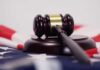 Judge’s gavel on a base over an American flag