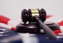Judge’s gavel on a base over an American flag