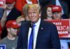 man in suit at rally podium
