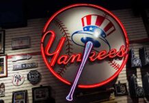 Neon Yankees sign on a wall of baseball memorabilia