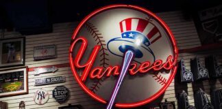 Neon Yankees sign on a wall of baseball memorabilia