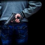 Livestream Murder Stuns Culiacán Plaza person holding a handgun behind their back
