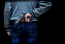Livestream Murder Stuns Culiacán Plaza person holding a handgun behind their back