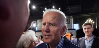Hunter’s Bombshell: Cancer Goes Further man in suit interacting with people at an indoor event