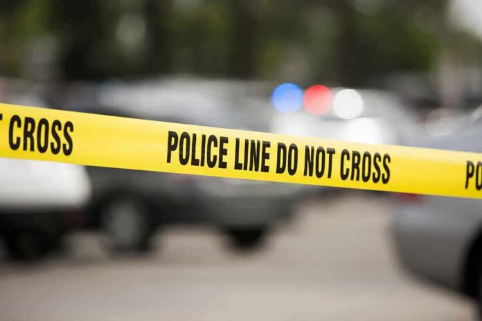 Yellow police line tape at a blurred street scene