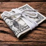 Stack of U.S. dollar bills tied with a white cord