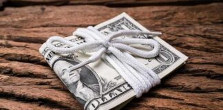 Stack of U.S. dollar bills tied with a white cord