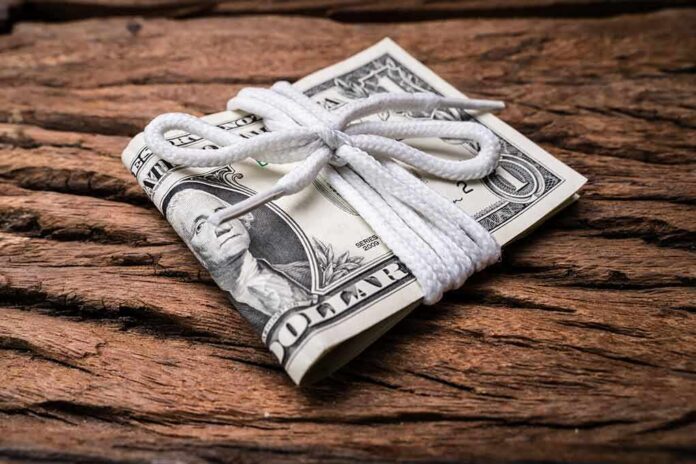 Stack of U.S. dollar bills tied with a white cord