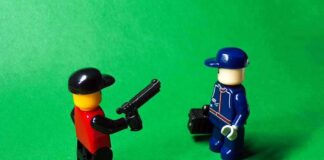 two lego minifigures facing each other on a green background