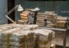 Europol-Backed Raids Cripple Sea Pipeline Stacks of wrapped packages on tables in a dim room