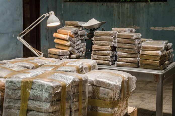 Stacks of wrapped packages on tables in a dim room