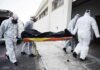 medical team in hazmat suits carrying a body on a stretcher