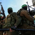 armed masked men in military gear holding rifles
