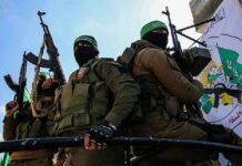 armed masked men in military gear holding rifles